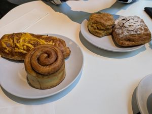 Sausage, egg and cheese; cinnamon roll (frosting not shown); biscuit; bear claw at Flour + Time Bakery in Atlanta