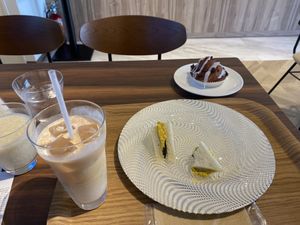 A sweet vegan soy milk tea, cinnamon roll, and the eggless sandwich that will eaten soon  at MERCY Vegan Factory in Osaka