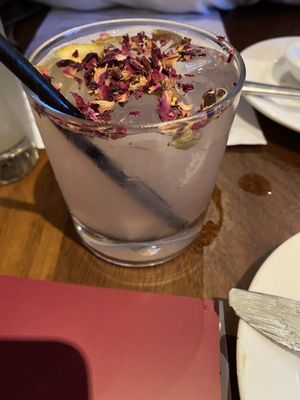 Rose Long Vodka - lemon-infused vodka, bitters, cardamom pods, and rose lemonade with rose petals garnish  at David Bann Restaurant in Edinburgh