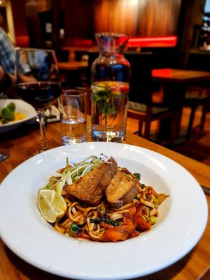 STIRFRIED VEGETABLES,
EDAMAME BEANS WITH
ORGANIC NOODLES, COOKED
WITH FRESH GINGER AND
GARLIC SPICES, SESAME
TATOSAUCE AND TOPPED
TH HOME SMOKED TOFU at David Bann Restaurant in Edinburgh