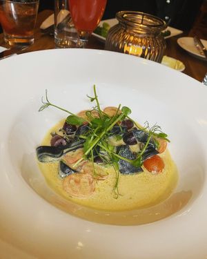 Black pappardelle - Homemade black pappardelle pasta cooked with asparagus, cherry tomatoes and black olives in a creamy smoked cheese sauce. Topped with dehydrated capers. [vg]  at David Bann Restaurant in Edinburgh