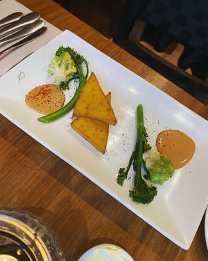 Coconut polenta with tikka massala cream and spiced brassicas [vg]  at David Bann Restaurant in Edinburgh