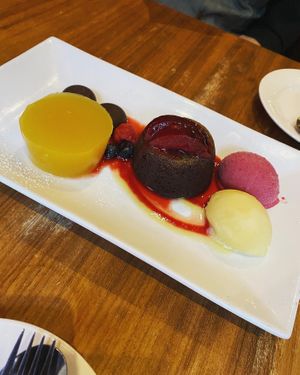 Vegan dessert for 2: Pineapple jelly, chocolate coulant cake and homemade orange marmalade chocolates. Served with pineapple sorbet and beetroot, coconut and whisky ice cream.   at David Bann Restaurant in Edinburgh