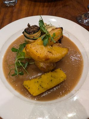 Haggis courgette rolls with crispy polenta, root veg, potatoes at David Bann Restaurant in Edinburgh