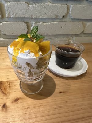 Vegan dessert with mango, whipped cream, cake and granola on the bottom. Plus coffee  at nagi in Nagoya