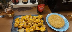 Patatas bravas and tortilla de patatas with chickpea flour at El Miau De Fucar in Madrid