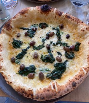 Yellow pizza with vegan cheese  at Martin Bros in Leicester