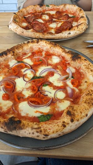 The Sgt.Peppers pizza: san marzano tomato base, fresh basil, fior-di-latte mozzarella, fresh red onion, peppadew peppers, topped with extra virgin olive oil. at Martin Bros in Leicester