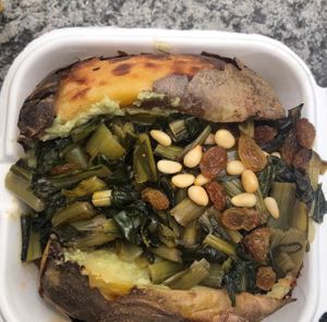 Jacked potato with pine nuts, fava cream, cicoria and raisins  at Poormanger in Milan