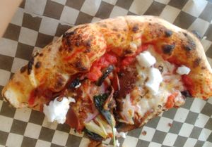Half-eaten Fun Guy (will upload a better pic later LOL!): tomato sauce, mushrooms, vegan pepperoni, goat cheese, basil, onion, garlic, truffle oil at Rawr Goods in Panama City