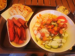 Salad with hummus and tofu, sweet potato fries at Csillag Büfé a Rómain in Budapest