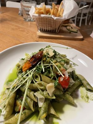 Pasta, nice herby taste with pesto and the pea shoots, I think. Burger in the background.  at Belse Restaurant NYC in New York City