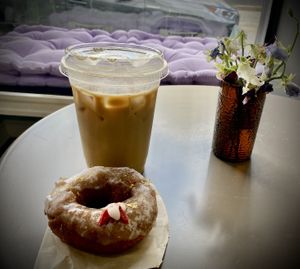 Delicious maple oat milk latte and yummy vegan donut at the Green Beautiful 💚  at The Green Beautiful  in Manchester