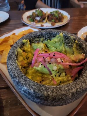 guacamole without cheese. pastor tacos in background at Xolo Taco in San Juan
