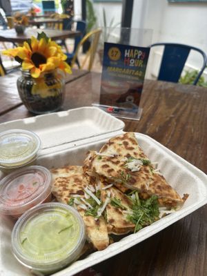 Vegan Pastor Quesadilla ( soy based chicken w/ pineapples). Wow - this was bursting with flavor! The spicy (green) sauce was great addition on the side. This place is super cute!   at Xolo Taco in San Juan