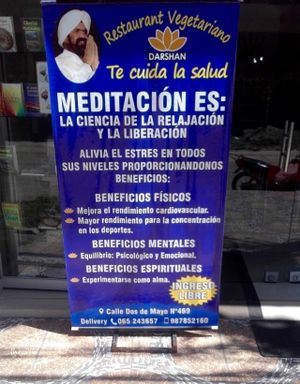Meditation sign outside the restaurant. at Darshan Vegetarian Restaurant in Iquitos