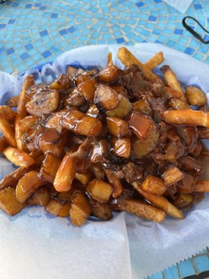 Vegan loaded fries, delicious! Jackfruit and sweet plantains with two amazing sauces- tangy bourbon and spicy sweet guava!  at Cultural Kitchen Catering in Jacksonville