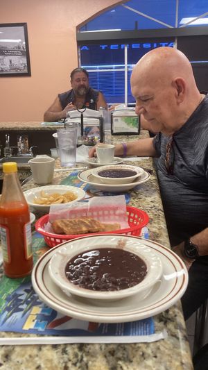 Customer eating black lentil soup at Saffron Indian Cuisine in Tampa