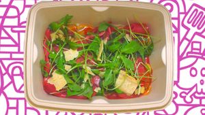 Thin Sliced VEGAN Bresaola charcuterie topped with Rocket , Our signature Vegan Parmesan and drizzle with fresh lemon dressing.  at The Vegan Witch in Cambridge