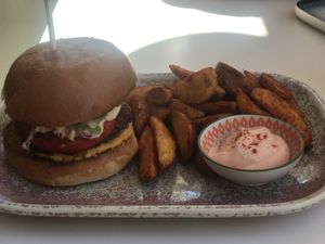 The Byron burger with their homemade cashew cheese sauce and sweet potato fries with yummy sauce   at Atheneon Bar in Kos