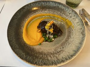 Oatmeal balls paired with sweet potato puree and a tangy balsamic vinegar reduction.   at Brocoli in Lyon