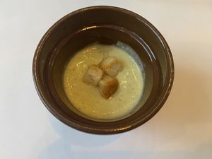 The meal starts with an amuse-bouche of broccoli and cauliflower soup, delicately flavored with smoked oil.  at Brocoli in Lyon