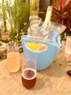 Mimosa bucket with orange, grapefruit and pomegranate juice. Prosecco is vegan.   at Somewhere in Rehoboth Beach