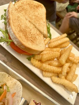 Tomato sandwich with arugula and vegan aioli and fries   at Somewhere in Rehoboth Beach