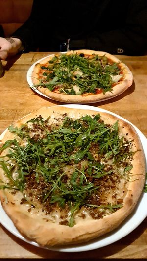 Sausage pizza and artichoke pizza at Vegan Pizza Bar in The Hague
