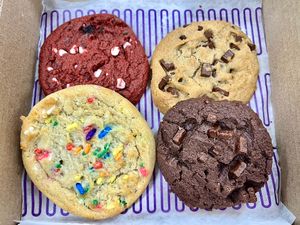 Vegan box! Clockwise from top left: Vegan Red Velvet special, Chocolate chunk, Double chocolate chunk, Birthday Cake 🎉   at Insomnia Cookies in Dayton