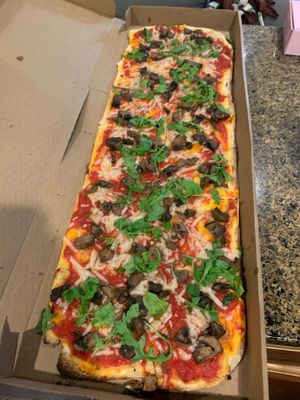 A large mushroom pizza substitute vegan cheese wowww look at the length  at Jules Thin Crust Pizza in Jenkintown