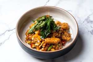 Stir Fries Plant-Based Fish with Fresh Chili and Garlic at Baanying's Plant-Based Ying's Garden  in Bangkok