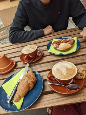 Capuccino with oatmilk, vegan butter bretzel and vegan croissant at Coffee & Panini in Ulm