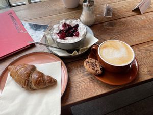 Vegan Croissant filled with jam, granola with coconut yoghurt and berries and oat cappuccino  at Coffee & Panini in Ulm