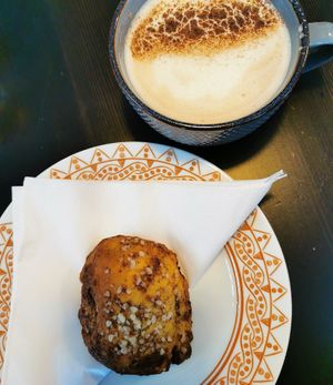 chai latte and a cinnamon bun at Encanto - Art Cafe in Helsinki