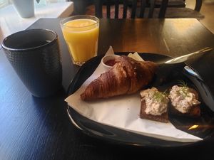 Croissant with jam and cheese, and daily specialty at Encanto - Art Cafe in Helsinki