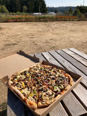 Lots of open space with tables and benches to sit outside and enjoy the food.  at OSM Eats in Langley