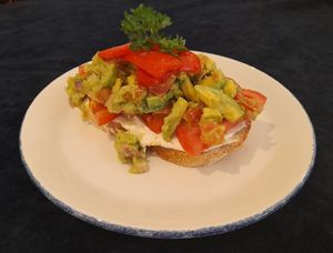 Menu Description: Smashed Avocado, roasted peppers, vegan cream cheese & sliced tomato on toasted sourdough at The Pantry in Reading