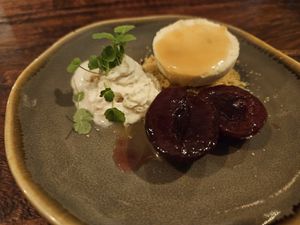 Dessert with pistachio/macadamia parfait, espuma, plum at Gärtnerei  in Essen