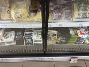 Lower shelf of yet more vegan feta cheeses and Violife choco spread, grated cheese and Benecol margarine.  at AB Vassilopoulos in Planos