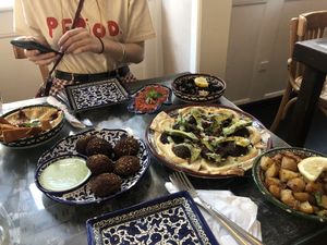 The falafel salad, humus with fried flat bread, the olive salad, the muhamara dip, chili/garlic potatoes and falafels with chili and a dip  at Mahalle - Fiolstræde in Copenhagen