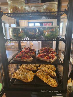 Herzhafte Vitrine mit Ziegenkäsebruschetta Bistrobaguette, grünem Salat und orientalischem Reissalat at Weltkind in Werneck