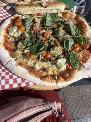 Soy meat, cherry tomatoes, artichoke and basil pizza   at PIZZABELLA in Santiago