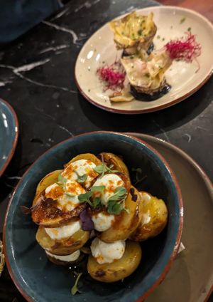 Velada bravas with aioli (artichoke flower in the background) at Velada in Barcelona