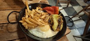 Eggs, fries and grilled peppers at Fogar do Santiso in Santiago De Compostela
