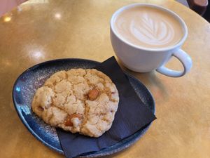 Lemon cookie with almonds and oat latte at Papegoye in Oslo