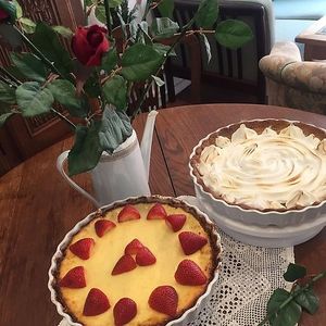 Homemade cheesecake with strawberries and a lemon-meringue pie at Café Hyggestund' in Birkeroed