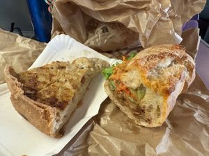 Apologies for the messy photo, took it on a train! Takeaway quiche and sandwich.  at Origin - Coffee Shop Végétal in Strasbourg