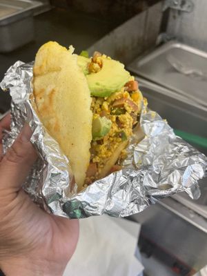 Colombia/Venezuelan- breakfast arepa- grilled corn cake stuffed with vegan veggie scramble, avocado cheese and house Inca sauce  at RiCoQui Plant-Based Street Food in Charlotte
