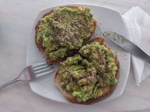avocado and tofu on toast topped with almonds at Triporto in Ios
